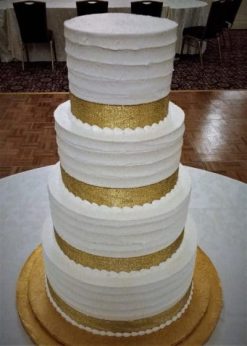 four tiered white and gold cake