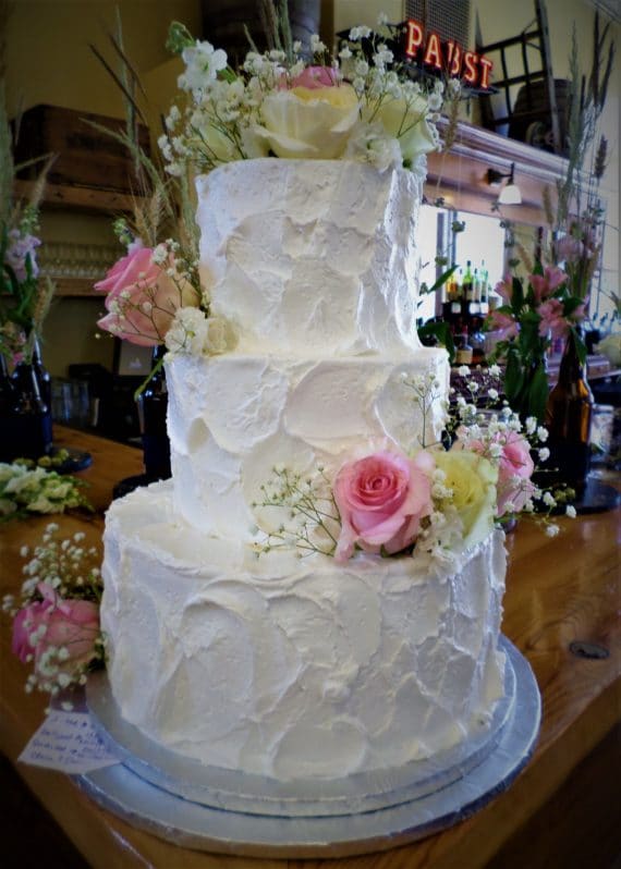 three tiered cake with flowers